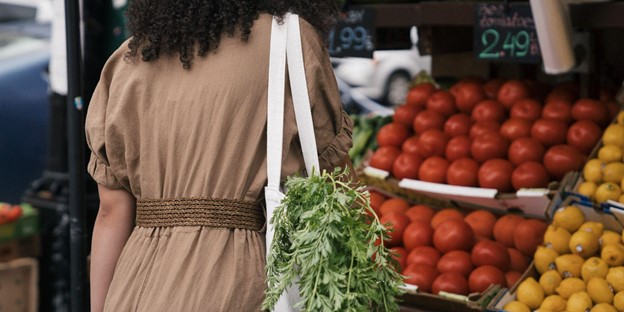 A woman using a reusable shopping bag