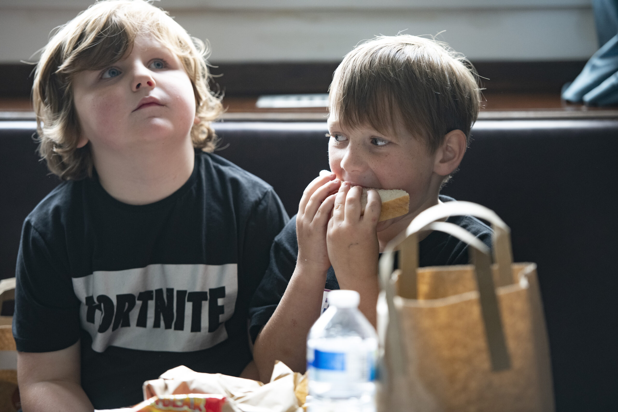 Two young boys eating lunch