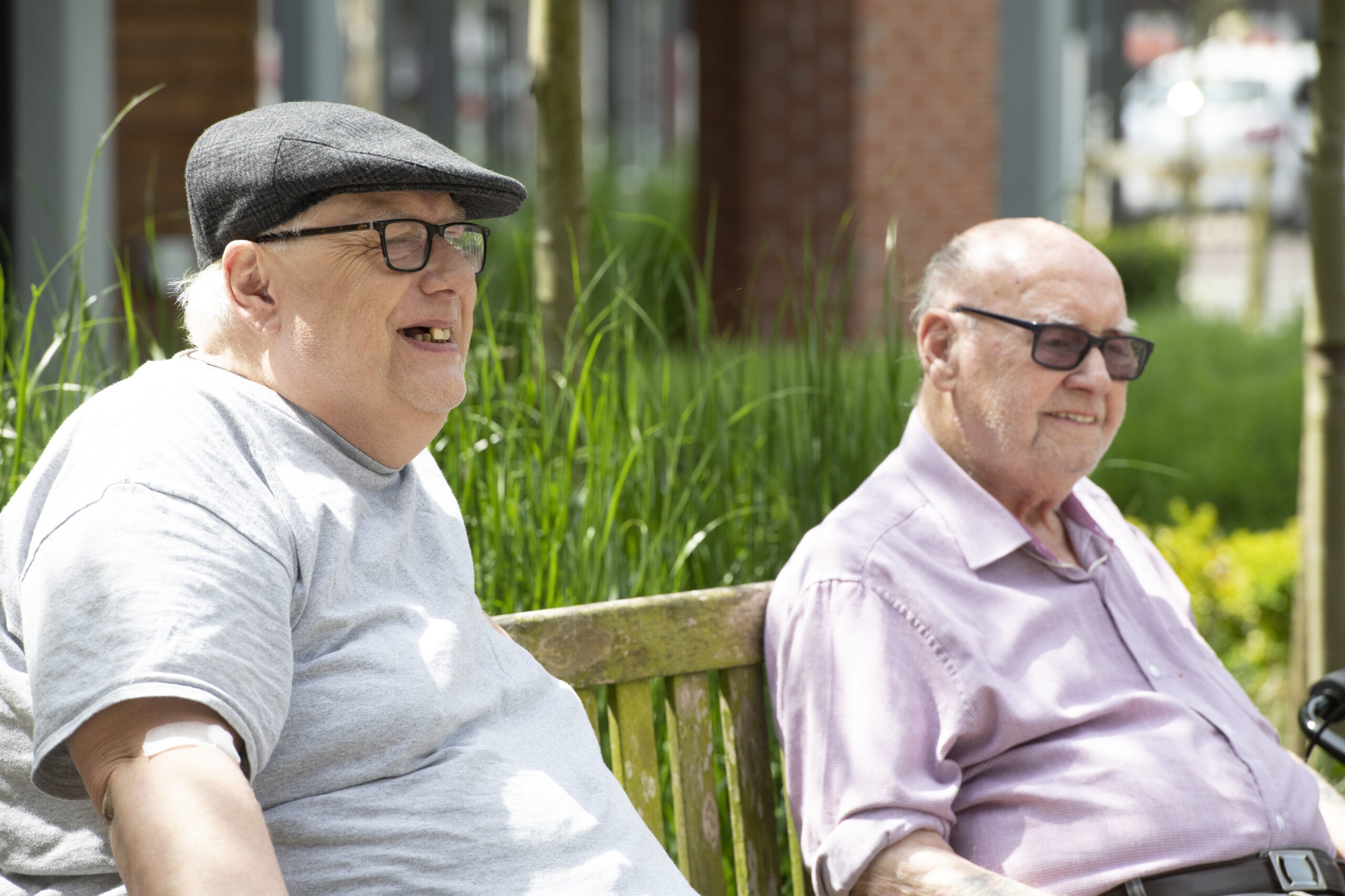 Two elderly men sat on a bench